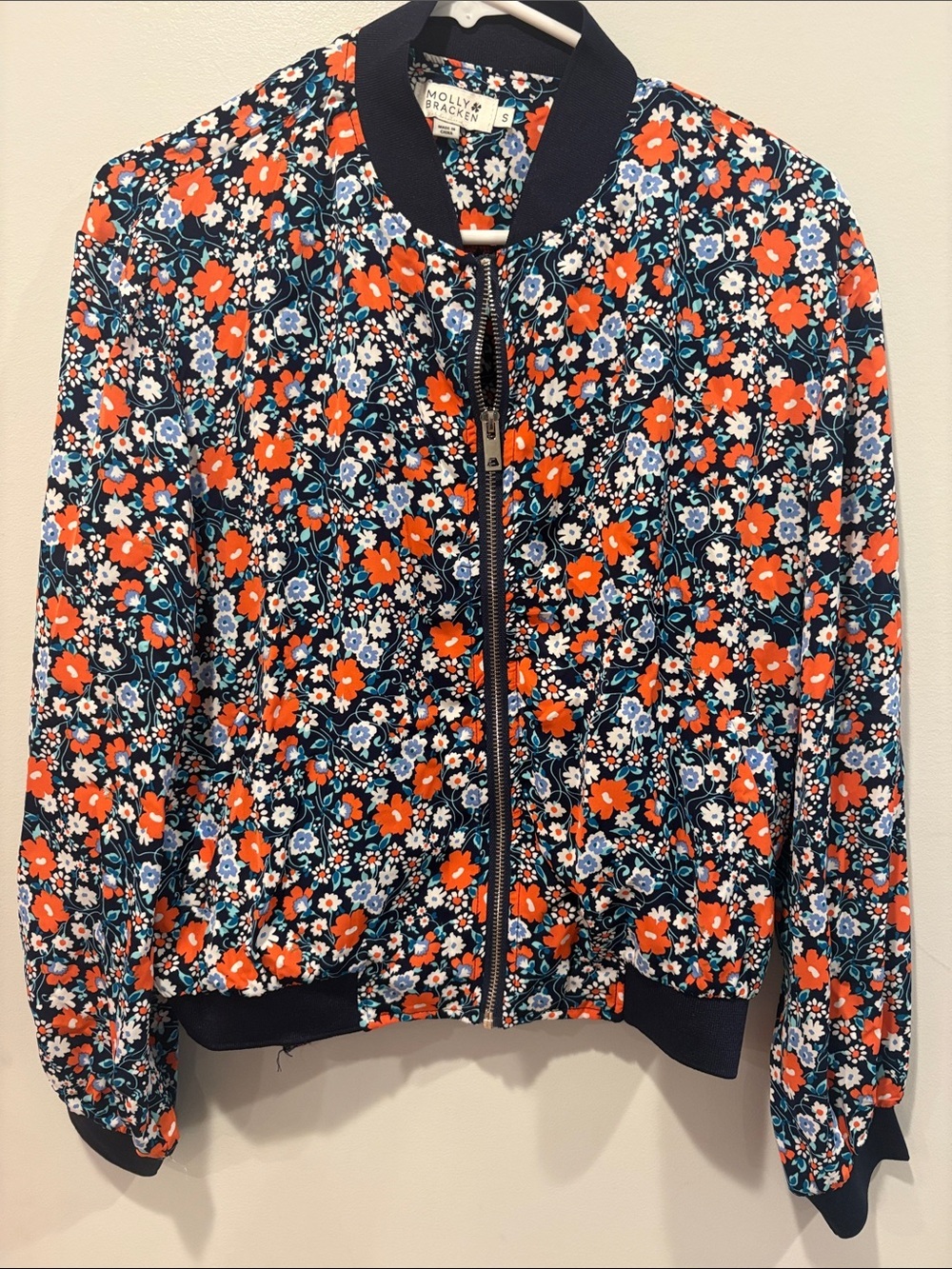 Molly Bracken Navy Floral Bomber Jacket with Orange Accents ptp 21 length 23